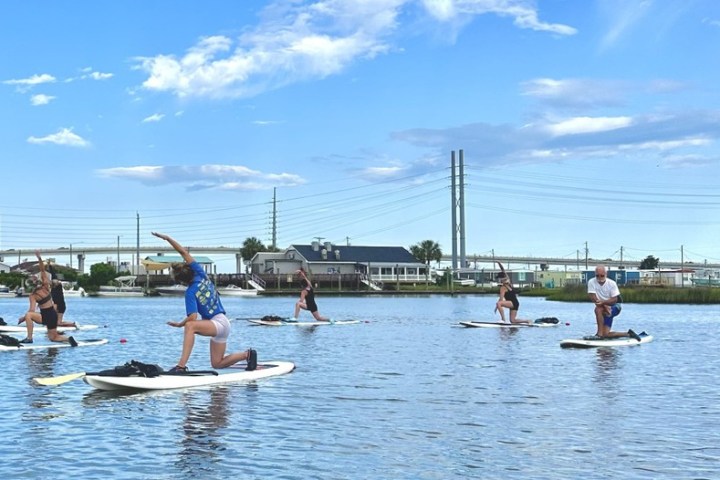 a group of people rowing a boat in the water